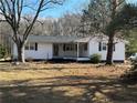 White ranch home with a covered porch and landscaped yard at 885 Dry Creek Rd, Lillington, NC 27546