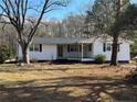 Charming white ranch house with a front porch and yard at 885 Dry Creek Rd, Lillington, NC 27546