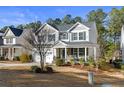 Two-story house with gray siding, white trim, and a stone front porch at 597 Micahs N Way, Spring Lake, NC 28390