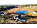 Aerial view of house and property, including a pond at 2477 Sheriff Watson Rd, Sanford, NC 27332