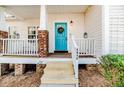 Inviting front porch with a bright blue door and white railings at 2817 Carolina Way, Sanford, NC 27332