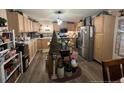 Galley-style kitchen with light wood cabinets and stainless steel appliances at 305 W K St, Erwin, NC 28339