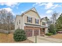 Charming two-story home featuring a brick facade, two-car garage and manicured landscaping at 323 River Oak St, Spring Lake, NC 28390