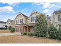 Charming two-story home featuring a brick facade, two-car garage and manicured landscaping at 323 River Oak St, Spring Lake, NC 28390