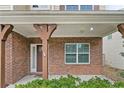 Inviting front porch with brick columns, offering a warm welcome at 323 River Oak St, Spring Lake, NC 28390