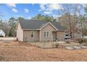 A fully fenced backyard with a concrete patio, and raised garden beds at 104 Exie Pl, Lillington, NC 27546