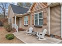 Inviting front porch features comfortable seating and charming curb appeal at 104 Exie Pl, Lillington, NC 27546