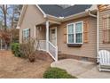 Charming front porch with a seating area and well-maintained landscaping at 104 Exie Pl, Lillington, NC 27546