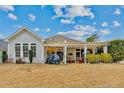 A backyard featuring a covered pergola, green lawn, offering an inviting outdoor living space at 15 Glenwood Ct, Spring Lake, NC 28390