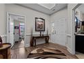 Well-lit foyer with a neutral color palette, hardwood floors, and a view into a bright office space at 15 Glenwood Ct, Spring Lake, NC 28390