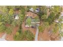 Scenic aerial view of the home nestled among mature trees on a sprawling lot at 16 Summer Breeze Ct, Cameron, NC 28326