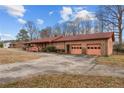 The exterior shows an attached garage and a spacious driveway, with a beautifully landscaped yard at 1916 Carr Creek Rd, Sanford, NC 27332