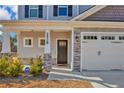 Close-up of the home's entrance, showcasing the front door, stone accents, and well-kept landscaping at 2538 Marks Rd, Cameron, NC 28326