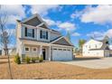 Inviting two-story home boasting a two-car garage, lovely landscaping, and a welcoming entrance at 2538 Marks Rd, Cameron, NC 28326