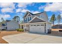 Beautiful two-story home with a spacious driveway and well-maintained lawn on a sunny day at 2538 Marks Rd, Cameron, NC 28326