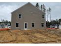 Home's backyard featuring a neutral color scheme and minimal landscaping at 288 Rocking Horse Ln, Sanford, NC 27332