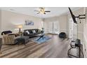 Bright living room with hardwood floors, a ceiling fan, and a glass door to the outside at 291 Gallery Dr # 202, Spring Lake, NC 28390