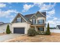 Charming two-story home with a well-manicured lawn and an attached two-car garage at 638 Century Dr, Cameron, NC 28326