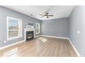 Inviting living room with a cozy fireplace, neutral paint, and lots of natural light at 638 Century Dr, Cameron, NC 28326