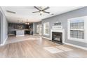 Open-concept living room featuring modern fireplace and adjoining kitchen at 638 Century Dr, Cameron, NC 28326