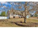 View of the home showcasing the front yard and landscaping at 10 Tory Ct, Lillington, NC 27546