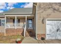 Inviting front porch with brick accents and access to the garage at 10 Tory Ct, Lillington, NC 27546