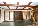 Entry foyer showcasing stone flooring, a large set of double doors and access to other parts of the home at 1468 Union Church Rd, Cameron, NC 28326