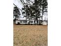 Cozy one story home with white siding, a lawn, and mature trees at 22176 Nc 24-27, Cameron, NC 28326