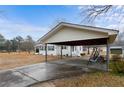 Covered carport featuring a concrete floor, metal beams, and a swing for relaxing in the shade at 4410 Cox Mill Rd, Sanford, NC 27332