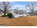 Charming single-story house with white siding, a covered front porch, and a detached carport at 4410 Cox Mill Rd, Sanford, NC 27332