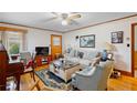 Cozy living room with hardwood floors, a ceiling fan, comfortable seating and ample natural light at 4410 Cox Mill Rd, Sanford, NC 27332