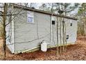 View of the side of the house showing the siding and an outdoor propane tank at 4454 Wire Rd, Linden, NC 28356