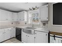 Bright kitchen featuring white cabinets, granite countertops, and a stainless steel sink at 4454 Wire Rd, Linden, NC 28356