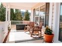 Inviting covered porch with rocking chairs, perfect for relaxing and enjoying the outdoors at 45 Trail Rider Ln, Sanford, NC 27332