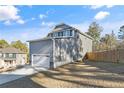 Exterior side view of a home with a two car garage and spacious backyard at 48 Cedarview Ct, Cameron, NC 28326