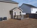 Backyard view with a deck, small outbuilding, and a grassy area next to the main home at 96 Boston Hbr, Cameron, NC 28326