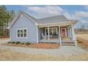 Inviting front porch with rocking chairs and bench seating, perfect for relaxing outdoors at 1139 Cranes Creek Rd, Cameron, NC 28326