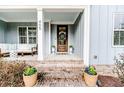 Inviting front porch with comfortable seating, stylish decor, and a charming entrance at 405 Clovermist Ct, Sanford, NC 27330