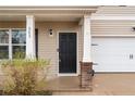 Inviting front entrance highlighting the front door, architectural columns, and easy access to the attached garage at 262 Shepard Dr, Linden, NC 28356