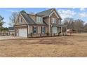 Side view of home featuring a two car garage and well-manicured landscaping at 31 White Tail Path, Erwin, NC 28339