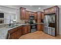 Kitchen featuring stainless steel appliances, wood floors, and granite countertops at 31 White Tail Path, Erwin, NC 28339