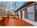 A spacious wooden deck with a painted railing, perfect for outdoor relaxation and enjoying the serene surroundings at 5802 Lillie Dr, Durham, NC 27712
