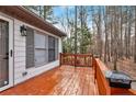 A spacious wooden deck with a painted railing, perfect for outdoor relaxation and enjoying the serene surroundings at 5802 Lillie Dr, Durham, NC 27712
