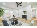 Inviting living room offers a vaulted ceiling, modern accents, and bright, natural light at 5802 Lillie Dr, Durham, NC 27712