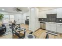 The living room flows into an eat in kitchen with modern appliances and stylish dining table for a complete space at 5802 Lillie Dr, Durham, NC 27712
