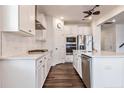 Modern kitchen featuring stainless steel appliances, white cabinets and marble countertops at 1029 Bellewood Park Dr, Angier, NC 27501