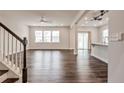 Bright, open-concept living room with hardwood floors and access to the kitchen at 1029 Bellewood Park Dr, Angier, NC 27501