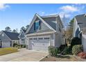 View of house exterior from street with well manicured lawn and attached garage at 159 Glenwood Ct, Spring Lake, NC 28390