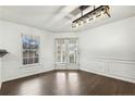 Dining area with hardwood floors, white trim, French doors to backyard, and modern light fixture at 220 Waters Edge Dr, Erwin, NC 28339