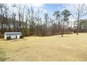 Expansive backyard featuring a shed with manicured lawn, providing a peaceful outdoor retreat at 3208 Westchester Dr, Sanford, NC 27330